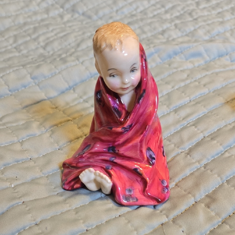 Porcelain Figurine with Red Blanket